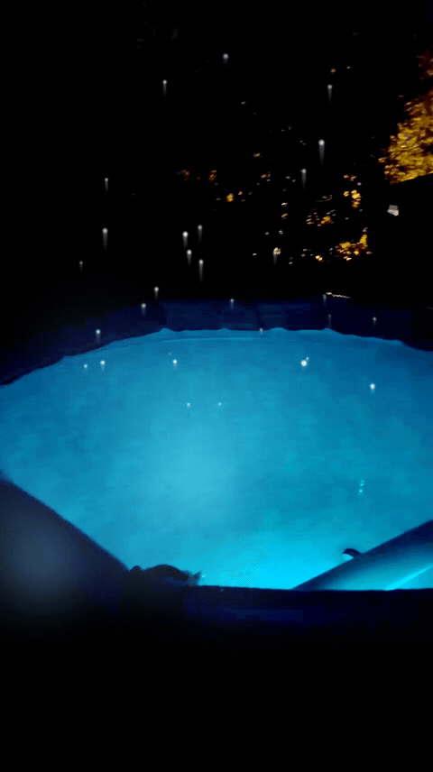 Bubbles floating over the pool at night